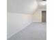 Large, carpeted attic area with white walls, sloped ceilings, and ample space at 3412 Hard Creek Ln, Buford, GA 30519