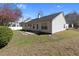 Backyard view with patio, green grass, and blooming tree at 3412 Hard Creek Ln, Buford, GA 30519