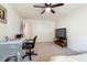 Spacious carpeted bedroom with a television, desk, and a ceiling fan at 3412 Hard Creek Ln, Buford, GA 30519
