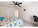 Carpeted bedroom featuring a ceiling fan, bed, and a workspace at 3412 Hard Creek Ln, Buford, GA 30519