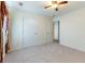 Bright, open bedroom features soft carpeting, a ceiling fan, and closet space at 3412 Hard Creek Ln, Buford, GA 30519