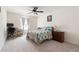 Cozy bedroom with carpet, ceiling fan, bed, desk, and natural light from the window at 3412 Hard Creek Ln, Buford, GA 30519