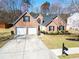 Traditional two-story brick home with a well-kept lawn, two-car garage and mailbox at 3412 Hard Creek Ln, Buford, GA 30519