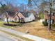 Landscaped front yard with a well maintained lawn and manicured flower beds by the sidewalk at 3412 Hard Creek Ln, Buford, GA 30519
