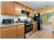 The kitchen features wooden cabinets, stainless steel appliances, and durable laminate countertops at 3412 Hard Creek Ln, Buford, GA 30519