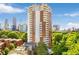 Stunning high-rise building featuring multi-level balconies, lush green trees, and skyline views at 375 Ralph Mcgill Ne Blvd # 804, Atlanta, GA 30312
