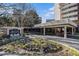 The City Heights Condominiums entrance with colorful flowerbeds and covered drop-off area at 375 Ralph Mcgill Ne Blvd # 804, Atlanta, GA 30312