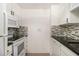 A kitchen featuring white cabinets, modern appliances, and a stylish tile backsplash, creating a clean and functional space at 375 Ralph Mcgill Ne Blvd # 804, Atlanta, GA 30312
