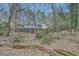View of the home from the wooded backyard, showing a spacious deck area at 1555 Sunnybrook Farm Rd, Atlanta, GA 30350