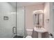 Updated bathroom with modern fixtures, a pedestal sink, and a glass-enclosed shower at 1555 Sunnybrook Farm Rd, Atlanta, GA 30350