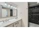 Modern bathroom featuring a double vanity and glass enclosed shower with dark tile at 1555 Sunnybrook Farm Rd, Atlanta, GA 30350