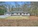 Inviting front exterior shot showcasing a charming home, grassy lawn, and nicely trimmed greenery at 1555 Sunnybrook Farm Rd, Atlanta, GA 30350