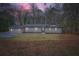 Inviting front exterior shot showcasing a well-lit home, grassy lawn, and nicely trimmed greenery at 1555 Sunnybrook Farm Rd, Atlanta, GA 30350