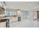 Bright, modern kitchen with stainless steel appliances, white cabinets, sleek countertops, and abundant natural light at 1555 Sunnybrook Farm Rd, Atlanta, GA 30350