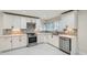 Modern kitchen featuring stainless steel appliances, white cabinets, sleek countertops, and stylish backsplash at 1555 Sunnybrook Farm Rd, Atlanta, GA 30350