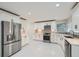 Modern kitchen with stainless steel appliances, white cabinetry, quartz countertops and tile backsplash at 1555 Sunnybrook Farm Rd, Atlanta, GA 30350