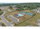 Aerial shot of community amenities including swimming pool, tennis courts, playground, and parking lot at 2560 Quarterdeck Dr, Cumming, GA 30041