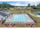 Aerial view showcasing community pool, playground, tennis courts, and surrounding landscape at 2560 Quarterdeck Dr, Cumming, GA 30041
