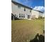 Backyard featuring lush lawn, small patio and privacy fence at 2560 Quarterdeck Dr, Cumming, GA 30041