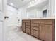 Bathroom featuring a double vanity, a large mirror, and a tub with a shower at 2560 Quarterdeck Dr, Cumming, GA 30041