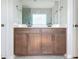 Bathroom vanity featuring double sinks, granite countertop, wood cabinets and modern fixtures at 2560 Quarterdeck Dr, Cumming, GA 30041