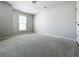Bright bedroom featuring a neutral color palette, plush carpeting, and a window with blinds at 2560 Quarterdeck Dr, Cumming, GA 30041