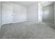 A spacious bedroom features neutral walls, plush carpeting and a white door at 2560 Quarterdeck Dr, Cumming, GA 30041
