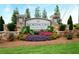 Community sign surrounded by colorful flower beds and manicured landscaping at 2560 Quarterdeck Dr, Cumming, GA 30041