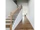 Inviting foyer leads to the living area featuring gleaming hardwood floors and a staircase at 2560 Quarterdeck Dr, Cumming, GA 30041