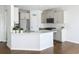 Stylish kitchen featuring white cabinets, quartz countertops, and modern appliances at 2560 Quarterdeck Dr, Cumming, GA 30041