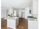 Open kitchen with large island, quartz countertops, white cabinetry, and stainless steel appliances at 2560 Quarterdeck Dr, Cumming, GA 30041