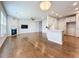 Open living space featuring hardwood floors, a fireplace, and a view into the kitchen at 2560 Quarterdeck Dr, Cumming, GA 30041