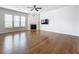 Spacious living room features hardwood floors, fireplace, ceiling fan, and television on the wall at 2560 Quarterdeck Dr, Cumming, GA 30041
