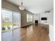 Open concept living room with sliding glass doors to the backyard, ceiling fan, and hardwood floors at 2560 Quarterdeck Dr, Cumming, GA 30041