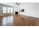 Spacious living room features hardwood floors, fireplace, ceiling fan, and television on the wall at 2560 Quarterdeck Dr, Cumming, GA 30041