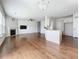 Open living space featuring a living room with a fireplace flowing into a kitchen area with white cabinets at 2560 Quarterdeck Dr, Cumming, GA 30041