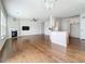 Open living space with living room flowing into a kitchen area with white cabinets and an island at 2560 Quarterdeck Dr, Cumming, GA 30041