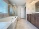 Main bathroom featuring soaking tub, separate glass shower, double sink vanity and natural light at 2560 Quarterdeck Dr, Cumming, GA 30041