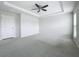 Spacious main bedroom featuring a tray ceiling, ceiling fan, neutral walls and plush carpeting at 2560 Quarterdeck Dr, Cumming, GA 30041