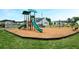 Community playground with slides, swings, and wood chip ground cover, surrounded by green grass at 2560 Quarterdeck Dr, Cumming, GA 30041