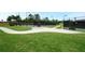 Well-maintained community tennis courts with a paved path and lush green surroundings at 2560 Quarterdeck Dr, Cumming, GA 30041