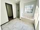 Bright bathroom features shower, jacuzzi tub and large window with natural light at 6159 Sable Fox Dr, Riverdale, GA 30296