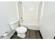 Bright bathroom featuring a standard toilet and tub with tile surround at 6159 Sable Fox Dr, Riverdale, GA 30296