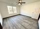 Bedroom showcasing wood-look flooring, a window, and a ceiling fan at 6159 Sable Fox Dr, Riverdale, GA 30296