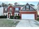 Charming two-story brick home with a two-car garage and manicured landscaping at 6159 Sable Fox Dr, Riverdale, GA 30296