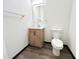 Half bathroom with modern sink, toilet, and new laminate flooring at 6159 Sable Fox Dr, Riverdale, GA 30296