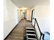 Bright hallway featuring wood-look floors and a staircase with black and white accents at 6159 Sable Fox Dr, Riverdale, GA 30296