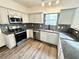 Kitchen featuring granite countertops, tiled backsplash, and stainless steel appliances at 6159 Sable Fox Dr, Riverdale, GA 30296