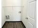 Utility room featuring laminate flooring and connections for a washer and dryer at 6159 Sable Fox Dr, Riverdale, GA 30296