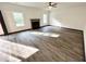 Bright living room with new laminate floors, a fireplace, and natural light at 6159 Sable Fox Dr, Riverdale, GA 30296